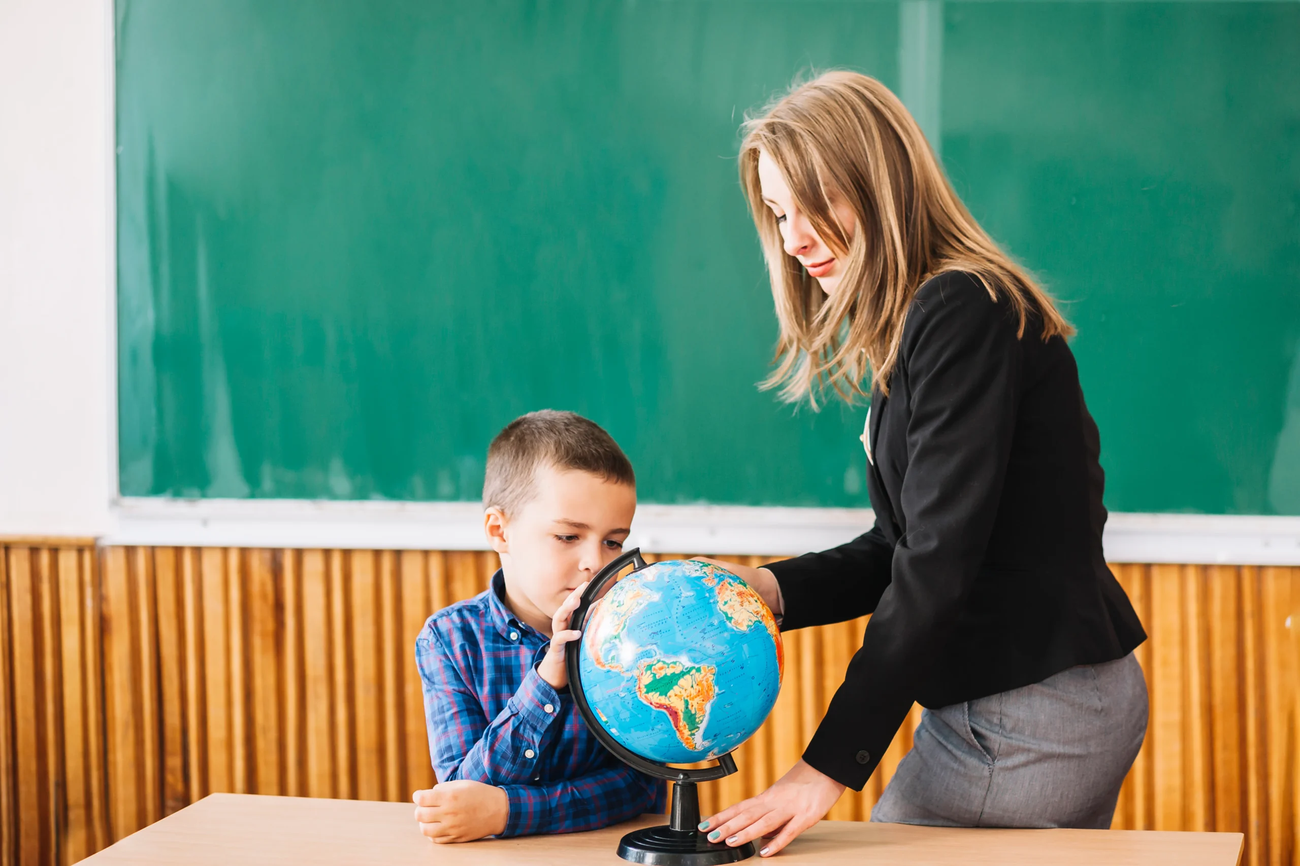 female-teacher-student-boy-working-with-globe