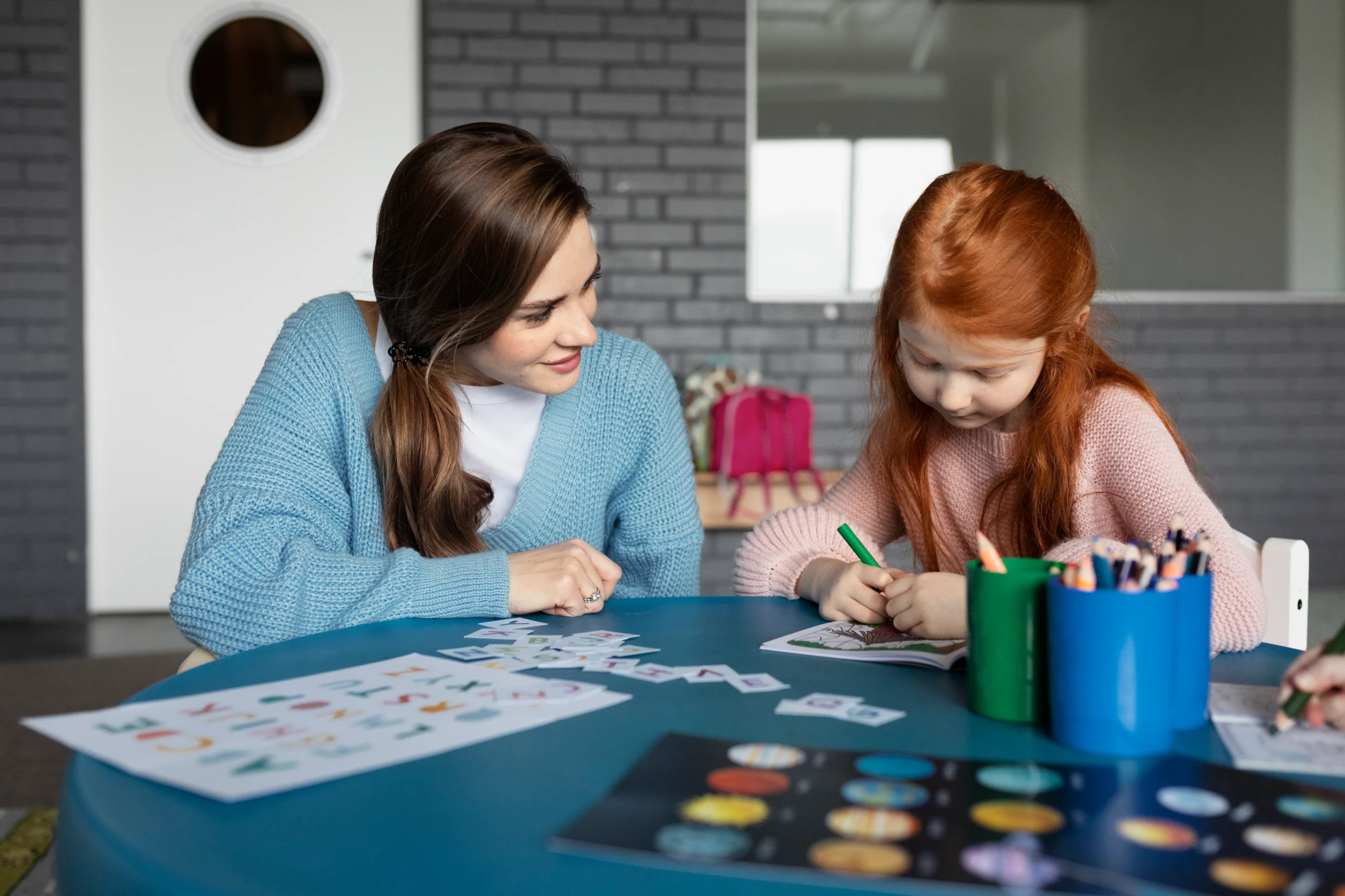 medium-shot-girl-coloring-table