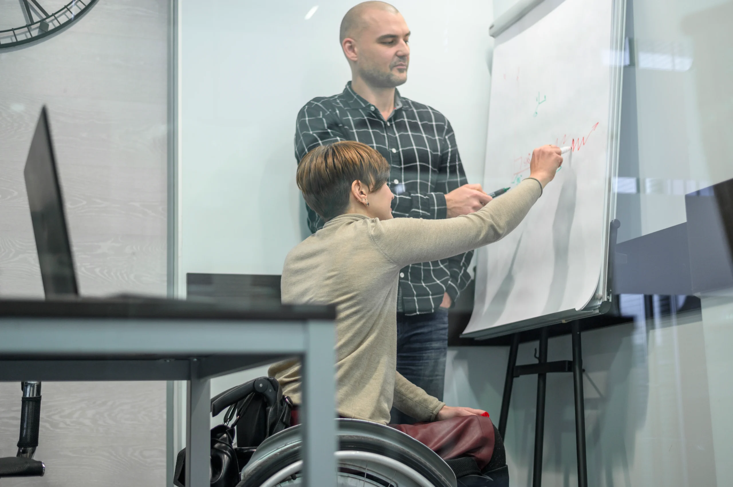 woman-wheelchair-writing-flip-chart